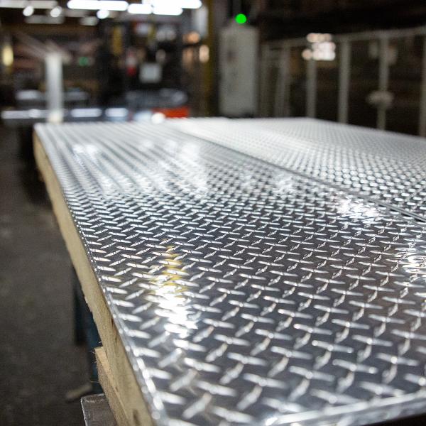 https://www.coremarkmetals.com/files/image/medium/aluminum diamond tread floor plate in warehouse